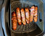 A picture of step 2 of Bacon wrapped cheddar Brats.
