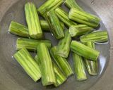 A picture of step 1 of Muniga badi jhola (Drumsticks & sun dried lentil dumplings).