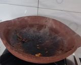 A picture of step 4 of Beans and rice sizzler in a clay pan.