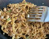 A picture of step 3 of Thai style egg noodles stir-fry served with fried egg.