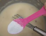 A picture of step 4 of Eggless mawa cup cake topping with shrikhand.