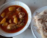 A picture of step 6 of Dhagi alu chicken.