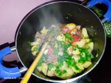Fried nduma with beef and potato served. with spinach