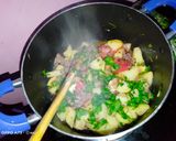 A picture of step 8 of Fried nduma with beef and potato served. with spinach.