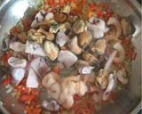 A picture of step 3 of Seafood Saganaki.