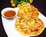 A picture of step 6 of Khatti meethi karee ki chutney with paratha.