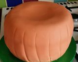 A picture of step 12 of Vickys Halloween Pumpkin Piñata Cake, Decorating Idea.