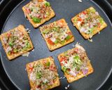 A picture of step 5 of Cream cracker pizza bites.