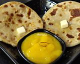 A picture of step 10 of Oats Paneer stuffed coin paratha with Aamras.