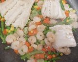 A picture of step 4 of My Saffron tumeric Rice with cod, prawns and veg.