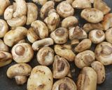 A picture of step 1 of Buttered Mushrooms in a little white wine and Balsamic Vinegar.