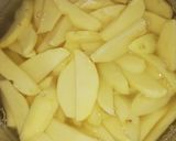 A picture of step 2 of Deep fried potato wedges.