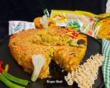 A picture of step 7 of Cheesy Maggi vegetable cake.