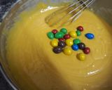 A picture of step 8 of Mango Blondie Bars with M&Ms.