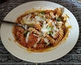 A picture of step 6 of Pasta sizzler sizzling with hot chilli powder, veggies, cheese.