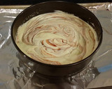 A picture of step 9 of White Layer Cake with a Raspberry Swirl Cheesecake center layer and a Raspberry Cream Frosting.