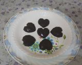 A picture of step 3 of (meethi recipe)Small pinnata heart shape dark chocolates.