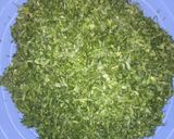 A picture of step 3 of Ugali,Omena and Greens,Served with an Orange fruit.