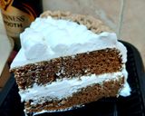 A picture of step 7 of Chocolate Guinness cake with whipped cream icing.