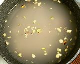 A picture of step 2 of Brown Rice & Chicken Congee.