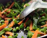 A picture of step 10 of Stuffed Riceballs tossed in mix vegetables.