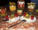 A picture of step 12 of Kunafa and Qashtalia Decorated with Oranges, Strawberries, and Bananas.
