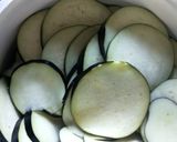 A picture of step 1 of Aubergine chips / baingan bhaja / Pan Chips.