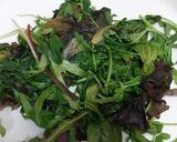 A picture of step 1 of Wilted greens with apples, raisins & nuts.