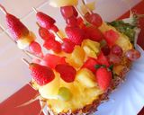 A picture of step 7 of Edible fruit arrangement on a pineapple boat.