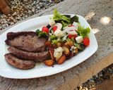 A picture of step 4 of Sirloin Steaks with fried baby potatoes & a greek salad.