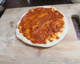 A picture of step 9 of Jain Cheese burst pizza.