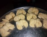 A picture of step 8 of Bow tie buns.