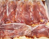 A picture of step 2 of Sun-dried tomato and prosciutto tear and share.
