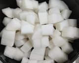 A picture of step 1 of Miso soup with tofu, daikon, onion.