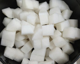 A picture of step 1 of Miso soup with tofu, daikon, onion.