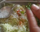 A picture of step 3 of Cucumber,Mint and Lemon grass Koshimbir with Tulsi leaves.