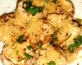 A picture of step 9 of Indian snack (crisp sphere with flavoured water/curd mixture).