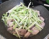 A picture of step 3 of Chinese stir-fried chicken and broccoli stems.