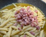A picture of step 6 of Pennette with Pancetta, Yellow Cherry Tomato Sauce, and Pecorino (Fake Carbonara).