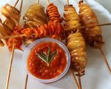 A picture of step 6 of Spiral potato and carrots on stick.