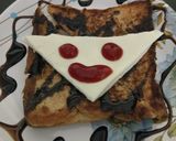 A picture of step 3 of Cheese toast with smiley.