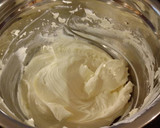 A picture of step 6 of Vanilla Lemon Raspberry Layer Cake with Whipped Cream Buttercream Frosting.