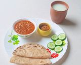 A picture of step 9 of Kathiyavadi lunch :Fresh lobiya Curry, Roti, Cucumber Slices, Pickle & buttermilk.