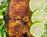 A picture of step 12 of Baked Tilapia Fish served with rocket leaves.