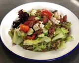 A picture of step 5 of Basque sausage, goats cheese, broad bean and spring onion salad.