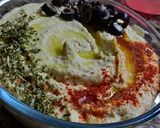 A picture of step 7 of Hummus with soda cracker.