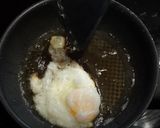 A picture of step 5 of My version of Thai Basil Beef (Pad Ka Prao) with dried chillies, topped with fried eggs.