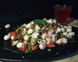 A picture of step 5 of Healthy Makhaana Salad with fruits veggies and nuts.