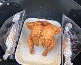 A picture of step 4 of Beer can chicken on the Braai (BBQ) with coal charred corn on the cob.