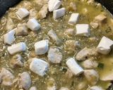 A picture of step 4 of Chicken Enchiladas (white sauce).